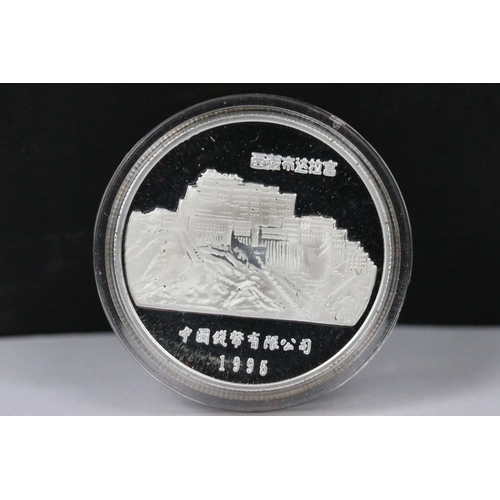 148 - A collection of twelve Chinese new year collectors coins encapsulated and contained within a two tie... 