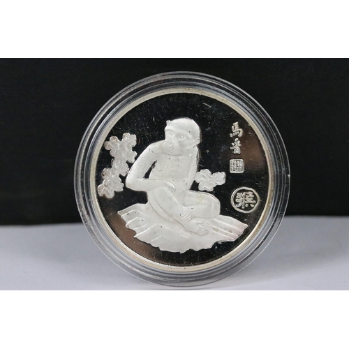 148 - A collection of twelve Chinese new year collectors coins encapsulated and contained within a two tie... 