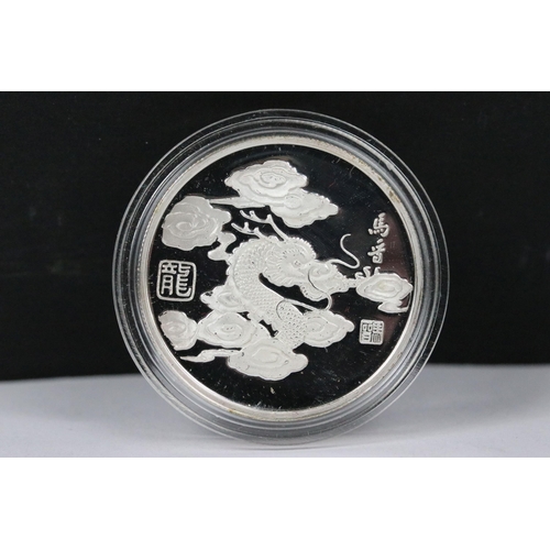 148 - A collection of twelve Chinese new year collectors coins encapsulated and contained within a two tie... 