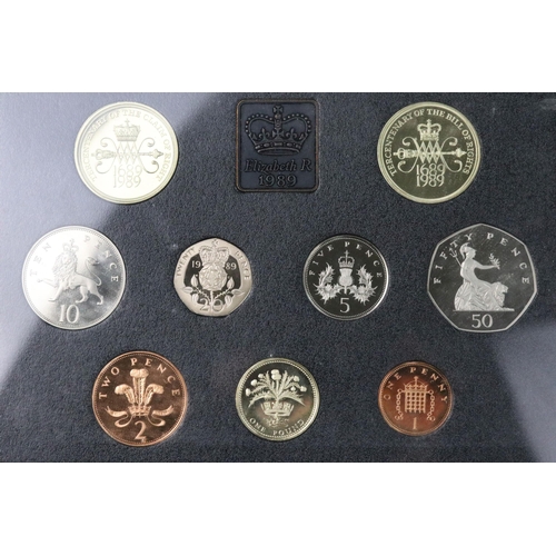 54 - A collection of six Royal Mint annual coin year sets to include brilliant uncirculated and proof exa... 