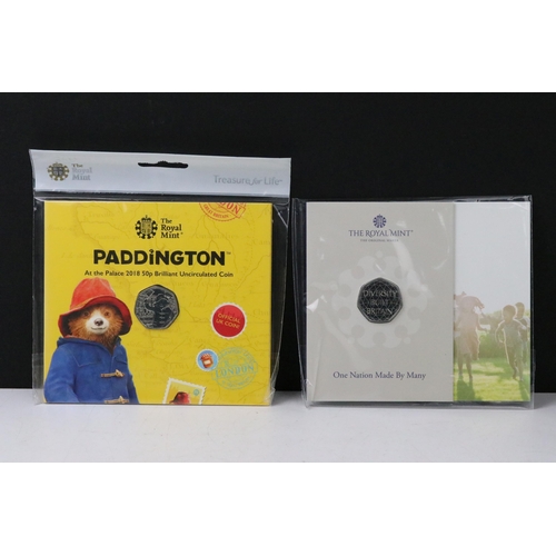 50 - A large collection of British Royal Mint commemorative 50p coin collectors packs to include Paddingt... 