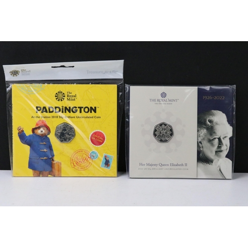 50 - A large collection of British Royal Mint commemorative 50p coin collectors packs to include Paddingt... 