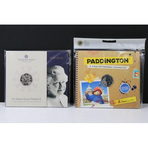 50 - A large collection of British Royal Mint commemorative 50p coin collectors packs to include Paddingt... 