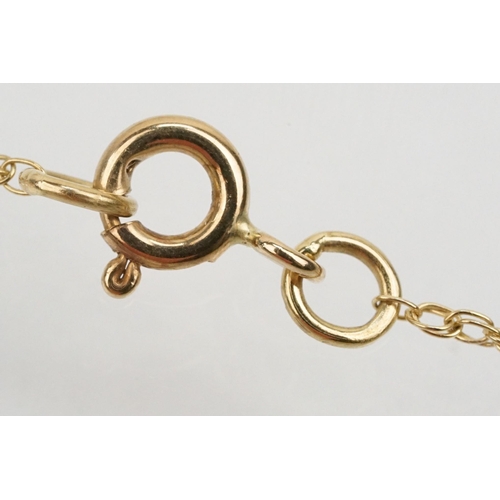 128 - Two 9ct gold fine link necklace chains to include a 9ct gold and sapphire pendant on a rolled gold f... 