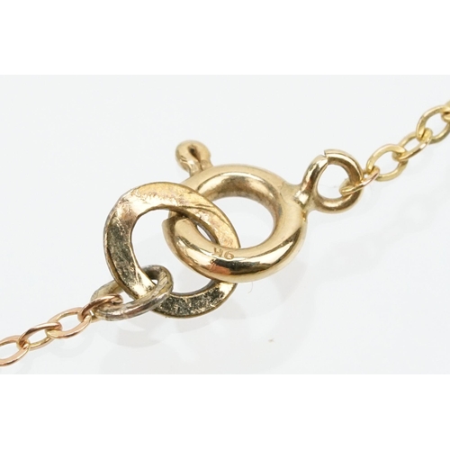 128 - Two 9ct gold fine link necklace chains to include a 9ct gold and sapphire pendant on a rolled gold f... 