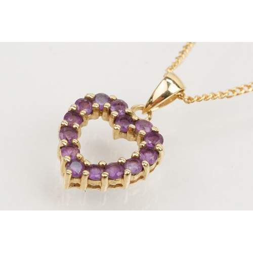 138 - 9ct gold amethyst pendant necklace with fine link chain having a heart shaped pendant set with round... 