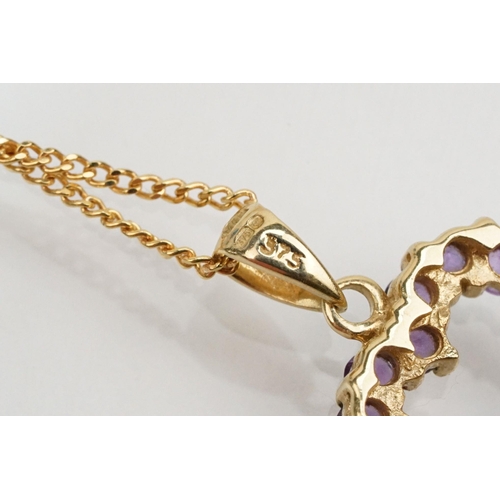 138 - 9ct gold amethyst pendant necklace with fine link chain having a heart shaped pendant set with round... 