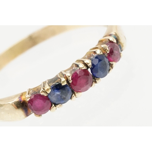 140 - 14ct gold ruby and diamond ring. The ring being set with three round cut rubies and two sapphires. M... 