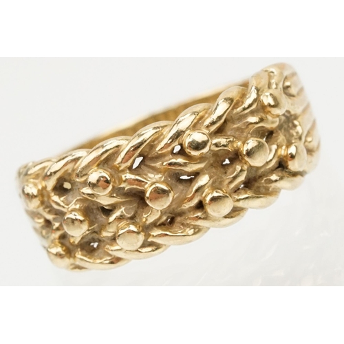 152 - 9ct gold keepers ring with knotted design head. Hallmarked Sheffield 1989. Size L.5.