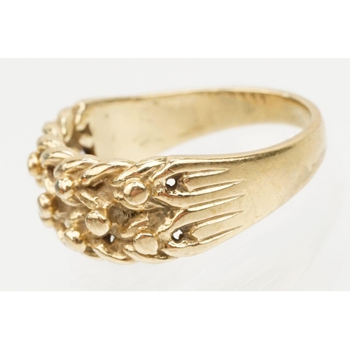 152 - 9ct gold keepers ring with knotted design head. Hallmarked Sheffield 1989. Size L.5.