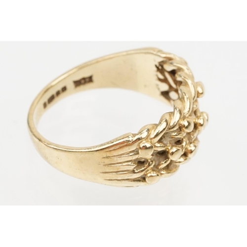 152 - 9ct gold keepers ring with knotted design head. Hallmarked Sheffield 1989. Size L.5.