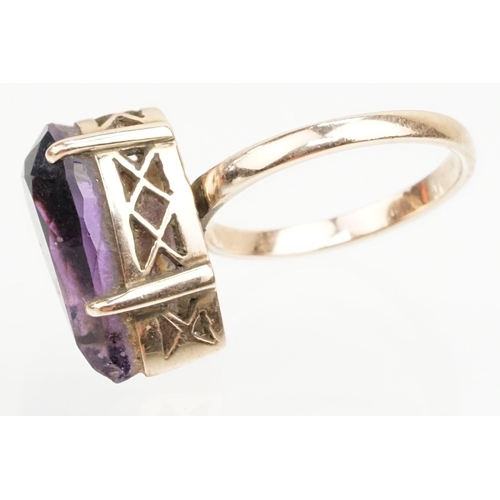 162 - Amethyst and yellow metal ring. The ring being set with a pear cut amethyst set within a basket sett... 