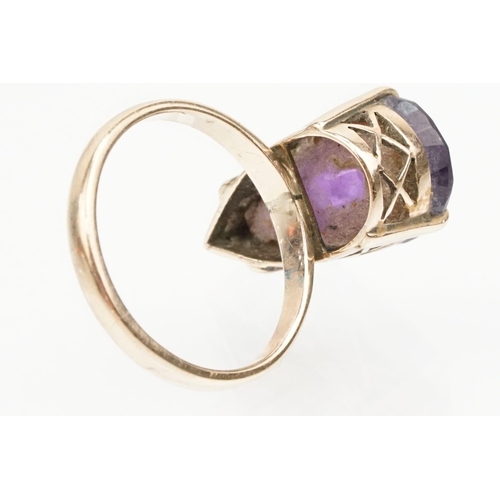 162 - Amethyst and yellow metal ring. The ring being set with a pear cut amethyst set within a basket sett... 