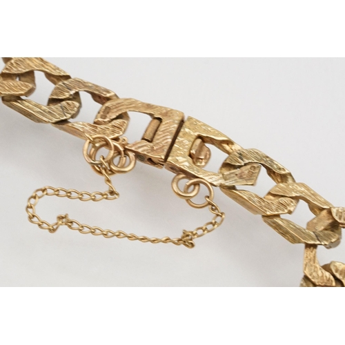 211 - 9ct gold identification bracelet with flat curb links and safety chain. Hallmarked London 1988. Brac... 