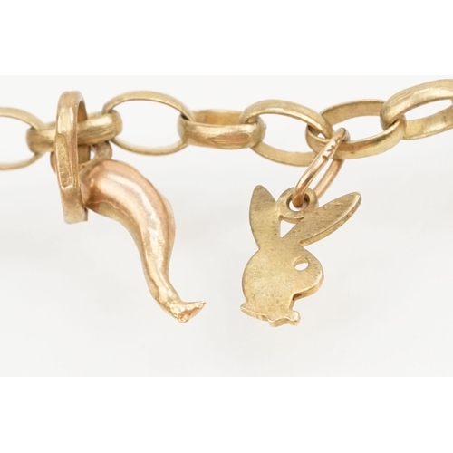 212 - 9ct gold charm bracelet having a spectacle chain with nine charms. Eight marked 9ct. Jump link hallm... 