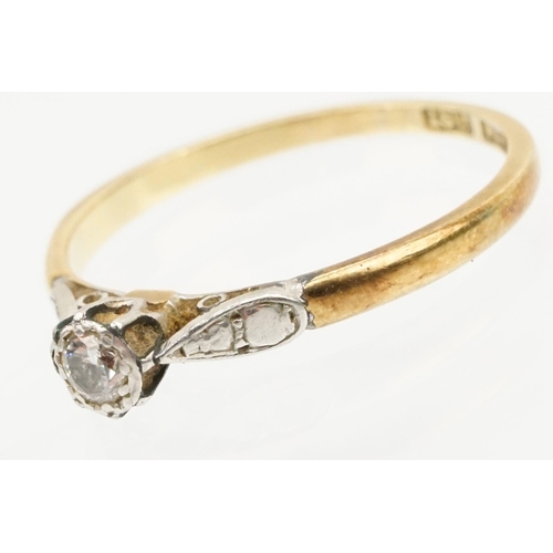 218 - 18ct gold and diamond ring being set with a round brilliant cut diamond on platinum shoulders. Band ... 