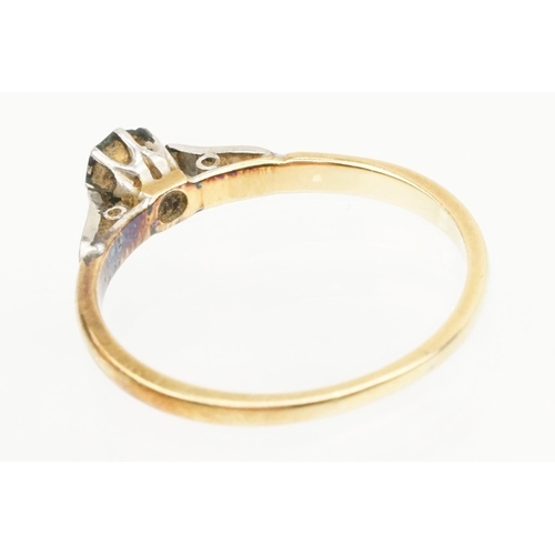 218 - 18ct gold and diamond ring being set with a round brilliant cut diamond on platinum shoulders. Band ... 