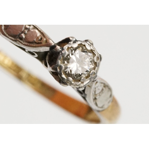 218 - 18ct gold and diamond ring being set with a round brilliant cut diamond on platinum shoulders. Band ... 