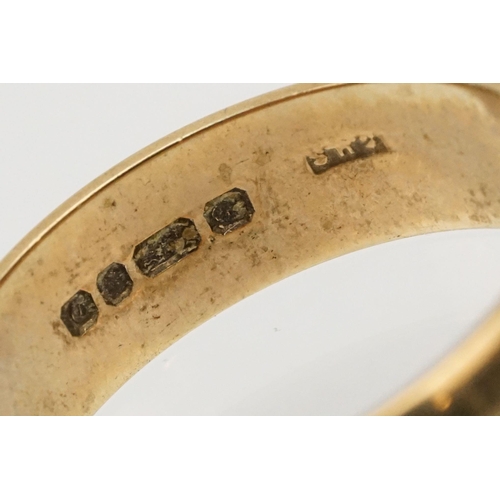 221 - Two 9ct gold wedding band rings to include a large ring of D form (hallmarked London 1978, size Q.5)... 