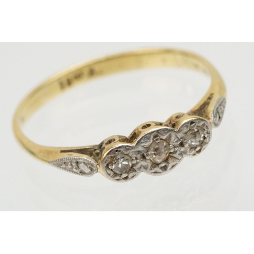 229 - Group of three gold rings to include an 18ct and platinum three stone ring (marked 18ct, size L.5), ... 