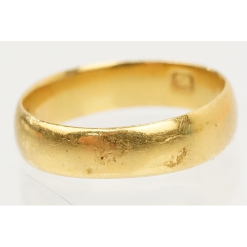 230 - Two gold wedding band rings to include a a hallmarked 22ct ring (Birmingham 1914, size K), and anoth... 