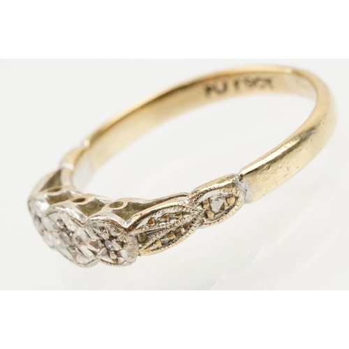 235 - 18ct gold and platinum three stone ring. The ring being illusion set with three round cut diamonds (... 