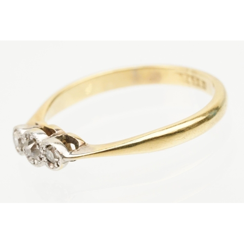 235 - 18ct gold and platinum three stone ring. The ring being illusion set with three round cut diamonds (... 