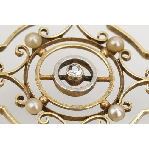 40 - Edwardian 15ct gold open work pendant being set with a diamond to centre with seed pearls surroundin... 