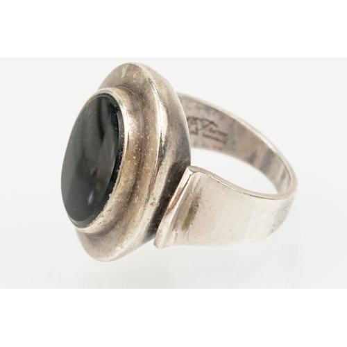 84 - Group of four Scandinavian silver mid 20th Century rings to include an N E From Danish black stone r... 