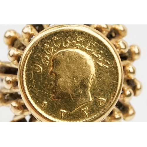 86 - 1/4 Pahlivi Iranian coin ring. The coin being set into a pierced setting with ball detailing. Ring u... 