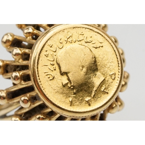 86 - 1/4 Pahlivi Iranian coin ring. The coin being set into a pierced setting with ball detailing. Ring u... 