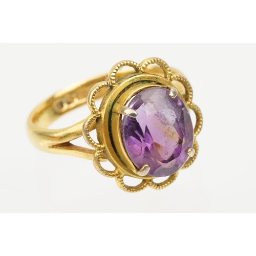 92 - 22ct gold and amethyst ring. The ring being set with an oval mixed cut amethyst in a pierced scallop... 