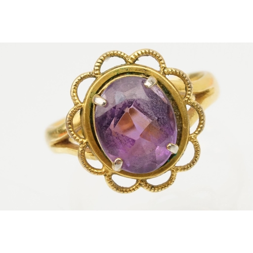 92 - 22ct gold and amethyst ring. The ring being set with an oval mixed cut amethyst in a pierced scallop... 