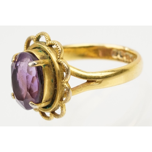 92 - 22ct gold and amethyst ring. The ring being set with an oval mixed cut amethyst in a pierced scallop... 