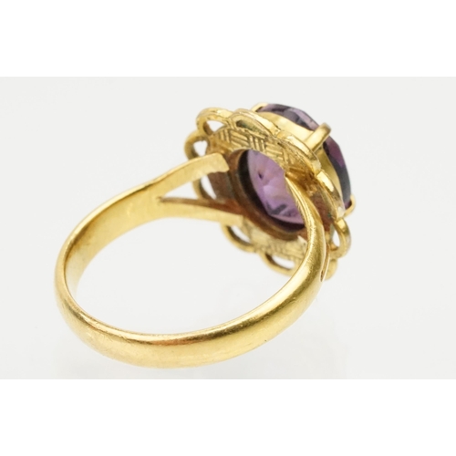 92 - 22ct gold and amethyst ring. The ring being set with an oval mixed cut amethyst in a pierced scallop... 