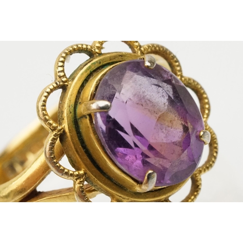 92 - 22ct gold and amethyst ring. The ring being set with an oval mixed cut amethyst in a pierced scallop... 