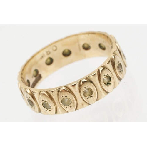 95 - 9ct gold eternity ring having a wide band with marquise moulded details and set with white stones. H... 