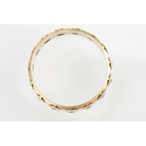 95 - 9ct gold eternity ring having a wide band with marquise moulded details and set with white stones. H... 