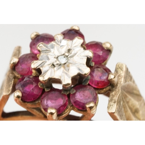 96 - 9ct gold ruby and diamond cluster ring. The ring being illusion set with a round cut diamond to cent... 