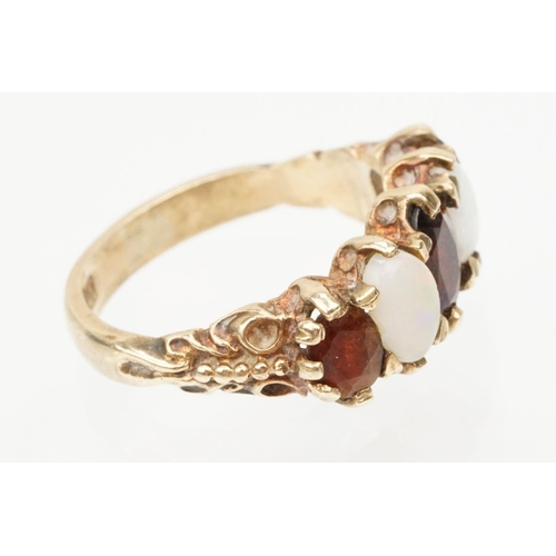 97 - 9ct gold garnet topped doublet and opal five stone ring. The ring being set with three oval cut GTD'... 