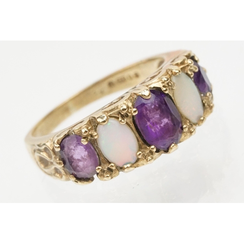 99 - 9ct gold amethyst and opal ring being set with three oval cut amethysts and two oval opal cabochons.... 