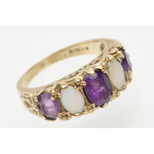 99 - 9ct gold amethyst and opal ring being set with three oval cut amethysts and two oval opal cabochons.... 