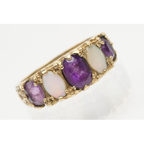 99 - 9ct gold amethyst and opal ring being set with three oval cut amethysts and two oval opal cabochons.... 