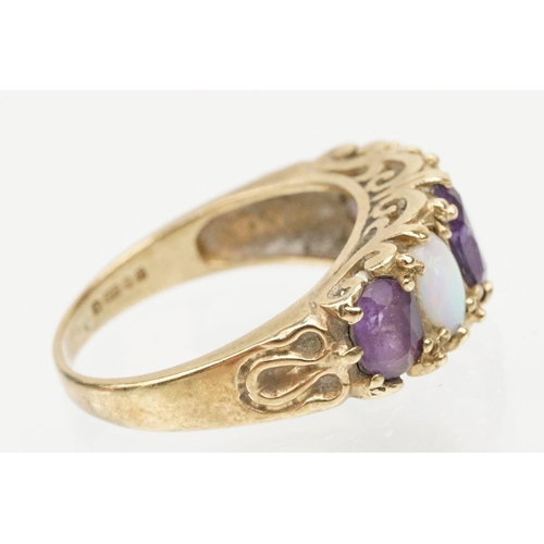 99 - 9ct gold amethyst and opal ring being set with three oval cut amethysts and two oval opal cabochons.... 