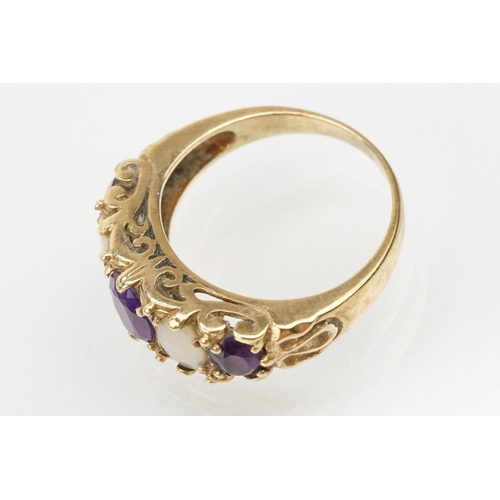 99 - 9ct gold amethyst and opal ring being set with three oval cut amethysts and two oval opal cabochons.... 