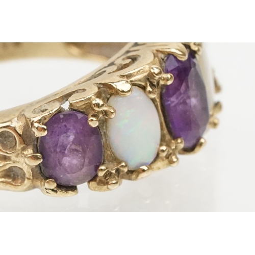 99 - 9ct gold amethyst and opal ring being set with three oval cut amethysts and two oval opal cabochons.... 