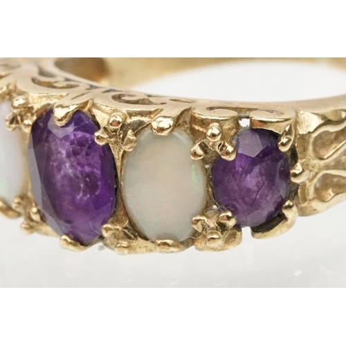 99 - 9ct gold amethyst and opal ring being set with three oval cut amethysts and two oval opal cabochons.... 