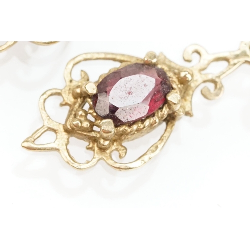 101 - Suite of 9ct gold and garnet jewellery to include a pendant necklace with fine link chain and scroll... 