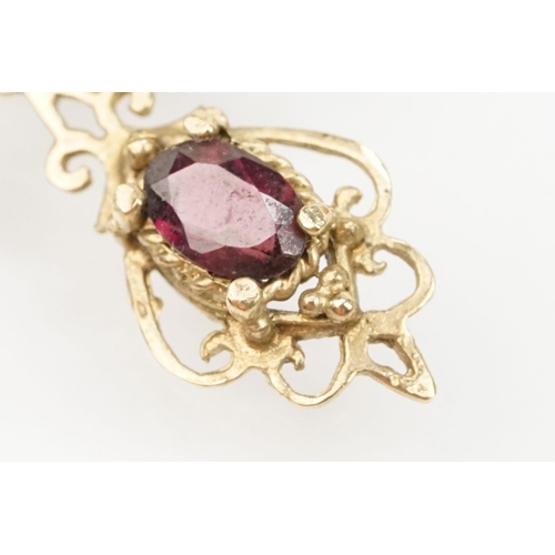 101 - Suite of 9ct gold and garnet jewellery to include a pendant necklace with fine link chain and scroll... 