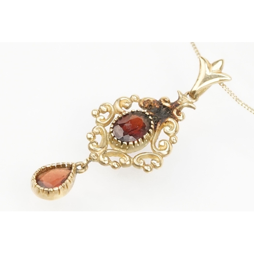 101 - Suite of 9ct gold and garnet jewellery to include a pendant necklace with fine link chain and scroll... 